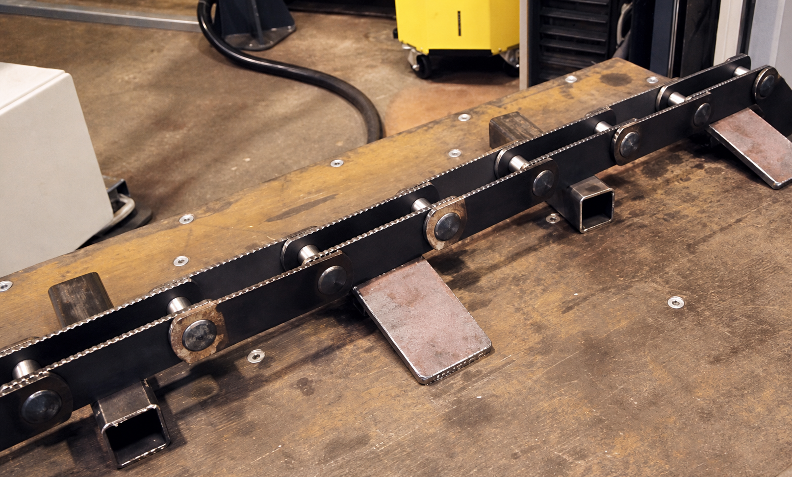 Finished chain-track weldment on the bench
