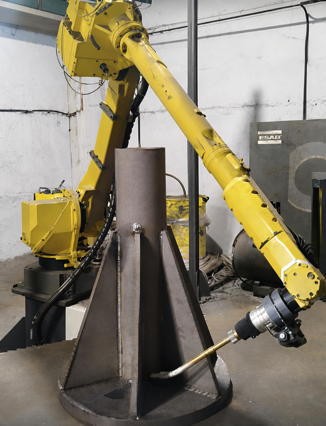 Robot arm welding a coned column base